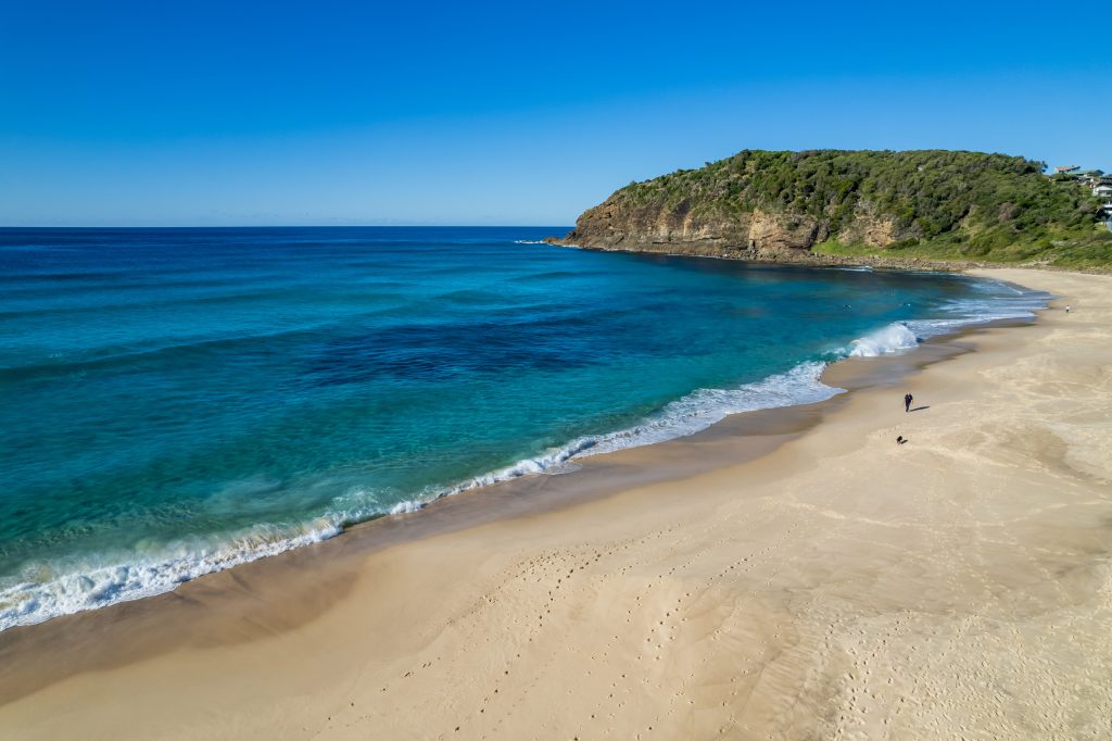 Turquoise summer waves rolling onto Boomerang Beach