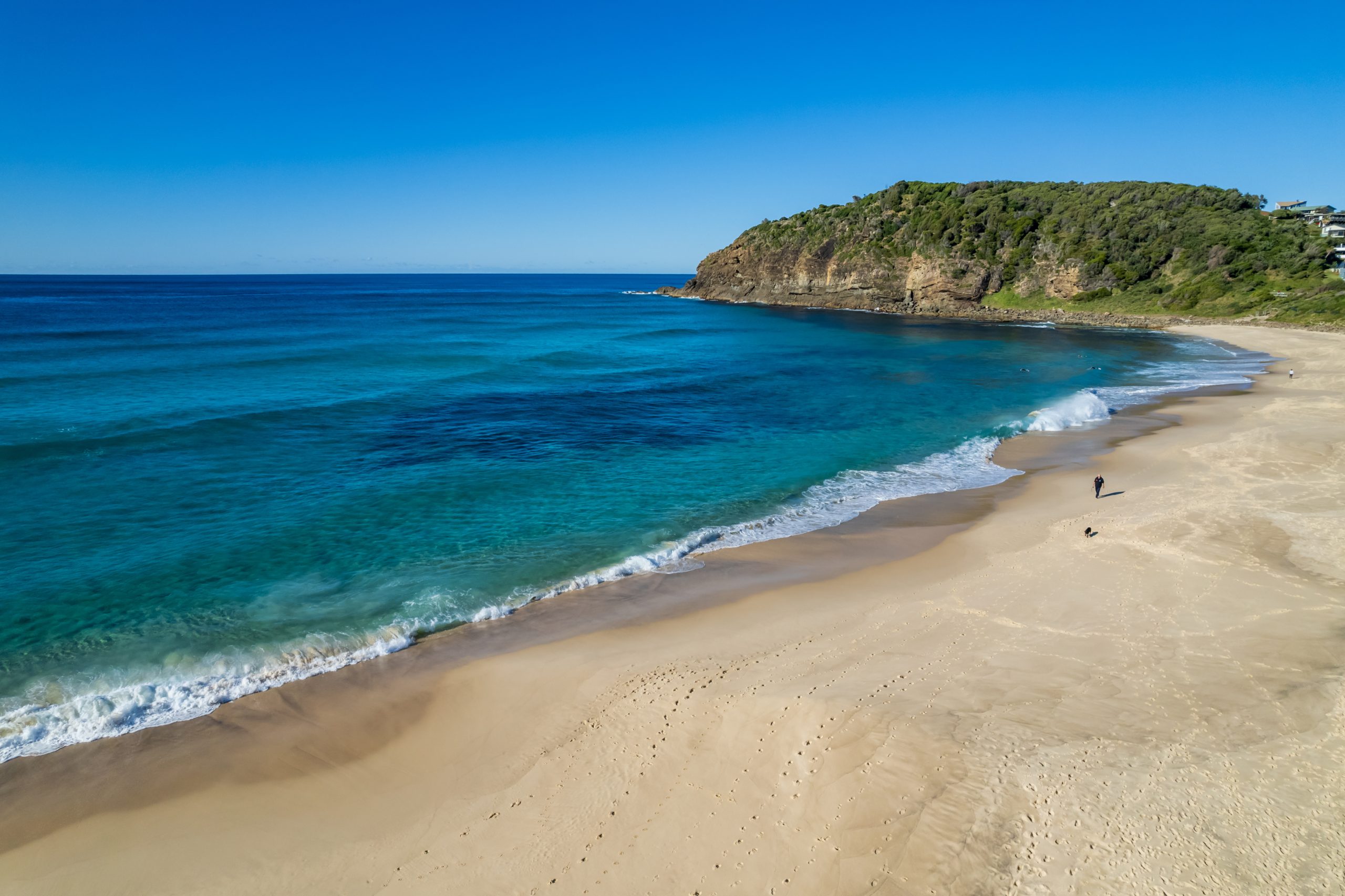 Turquoise summer waves rolling onto Boomerang Beach