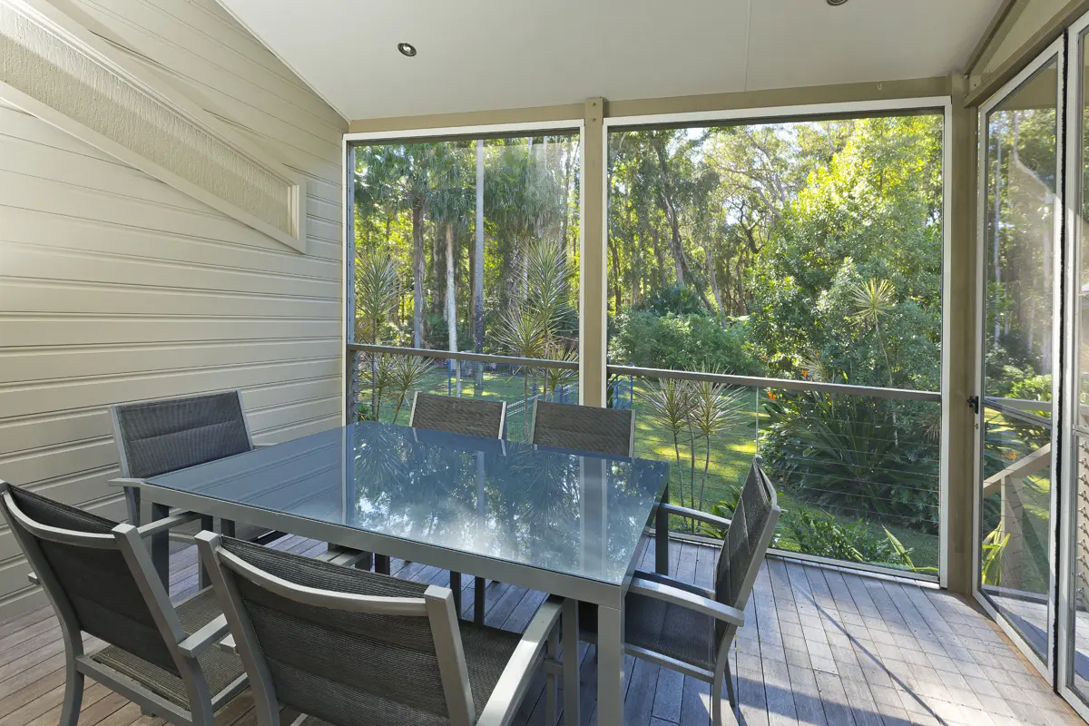 Screened outdoor dining area in a Two Bedroom Townhouse at Blueys Retreat
