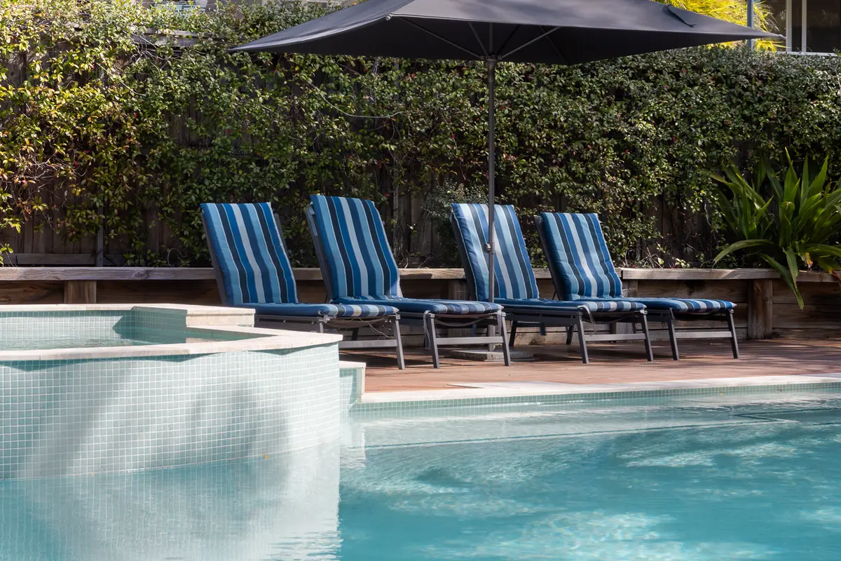 Swimming pool and poolside loungers at Blueys Retreat
